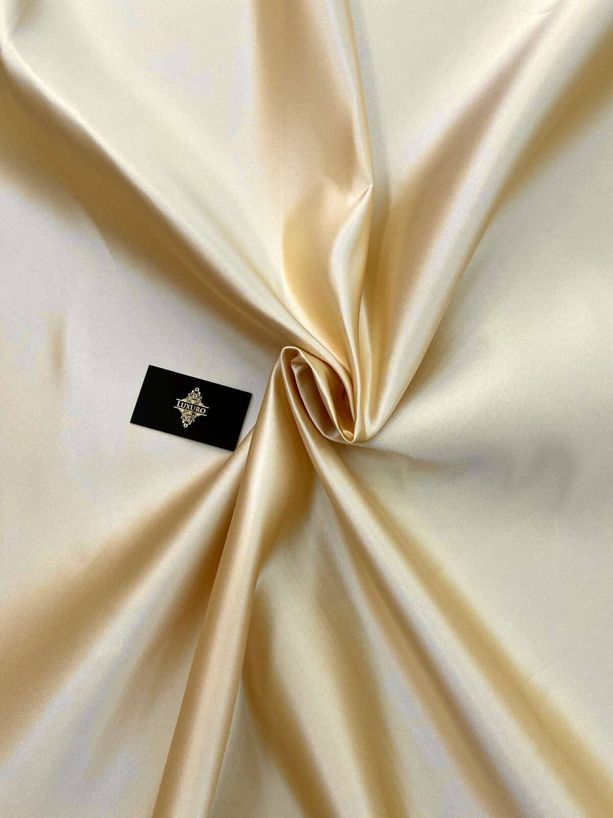 Champagne duchesse taffeta with pearl finish, draped