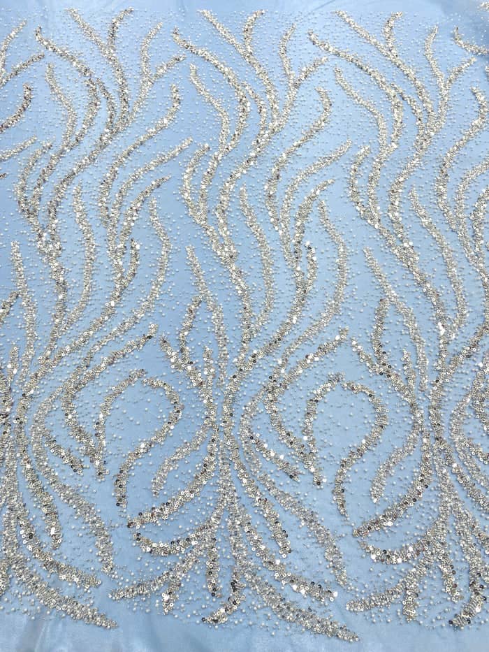 Silver couture lace on blue tulle with pearls, beads and sequins