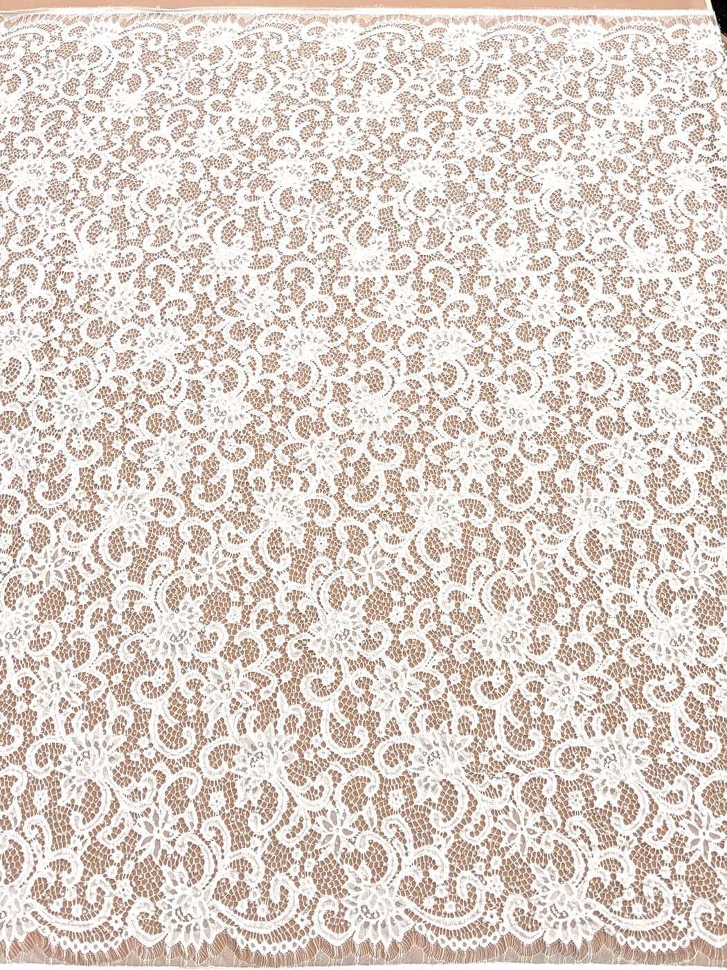 Ivory chantilly lace with pearls, beads and sequins, draped over blush
