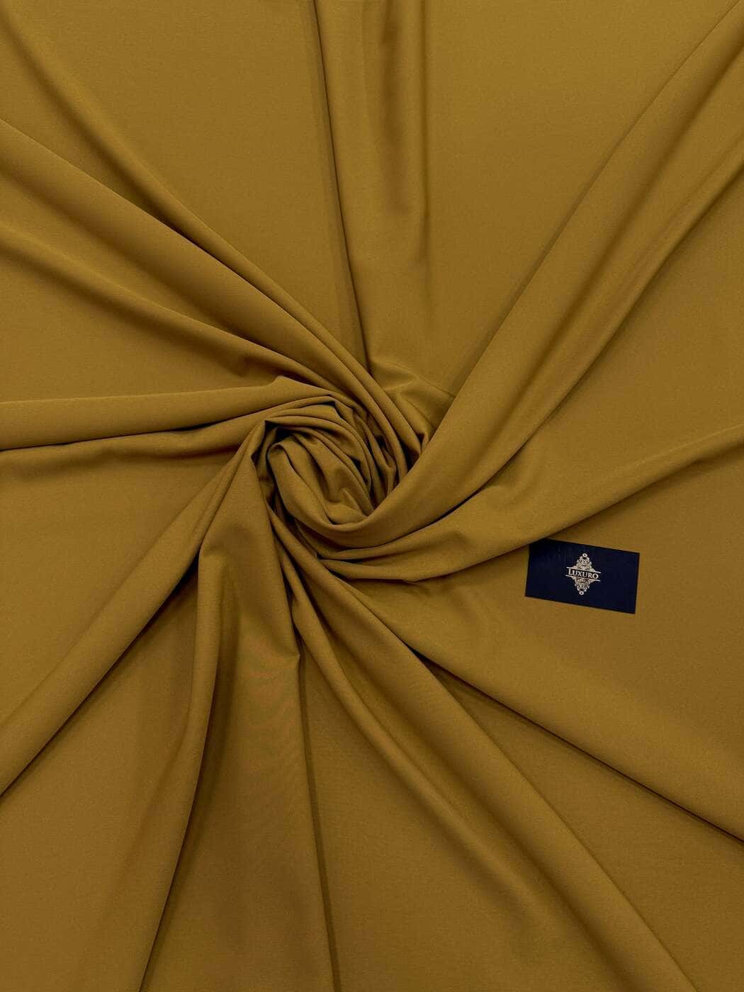 Mustard elastic crêpe swirled to show its matte drape