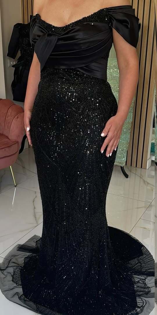 Black satin-bodice mermaid gown in beaded lace with a tulle train